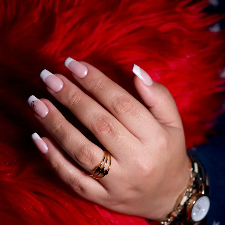 French manicure with rings and a gold watch