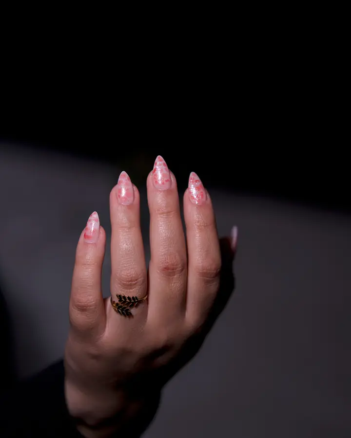 Nude glitter manicure with an ornate ring